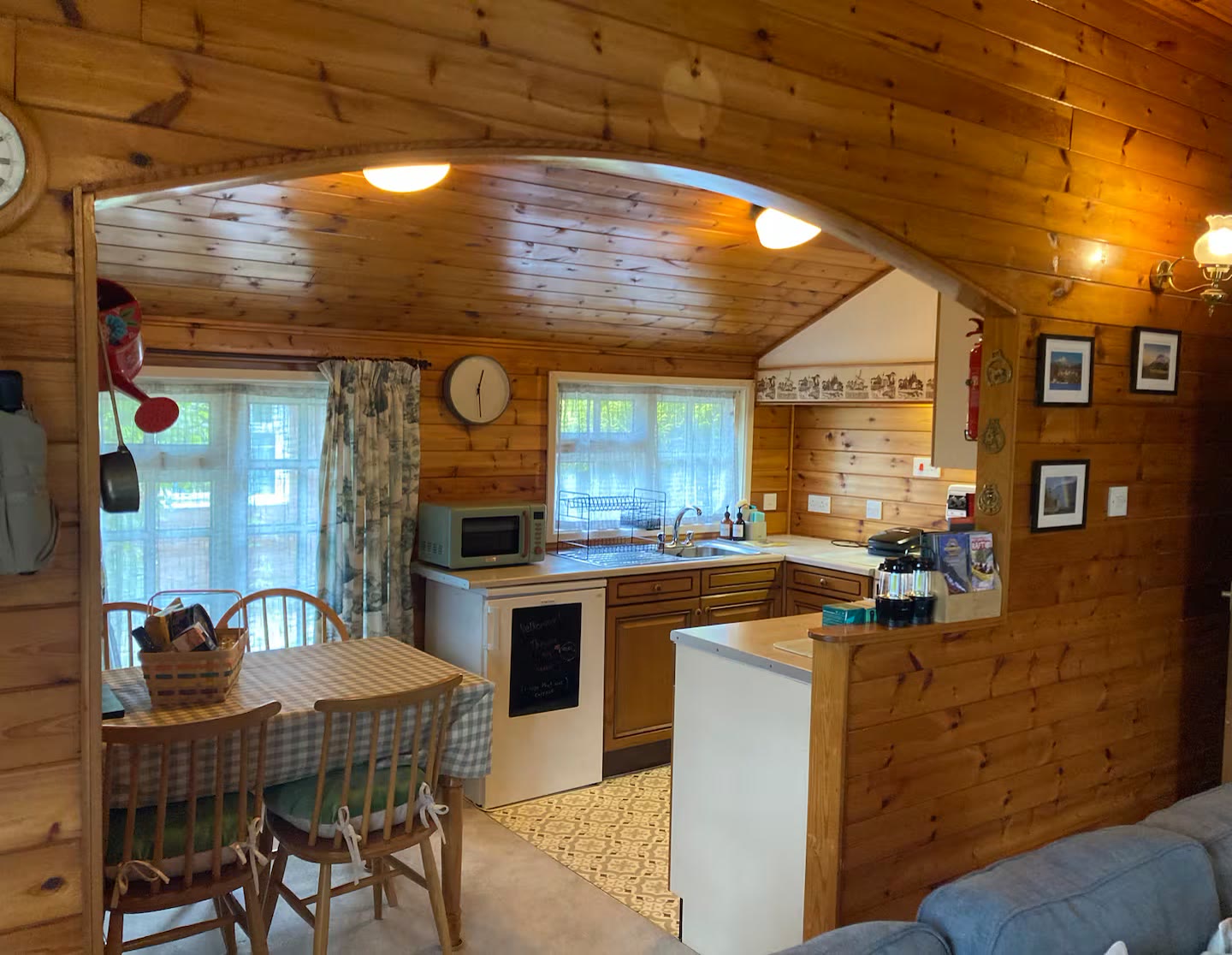 Kitchen with oven, hob and microwave, looking through to the dining table